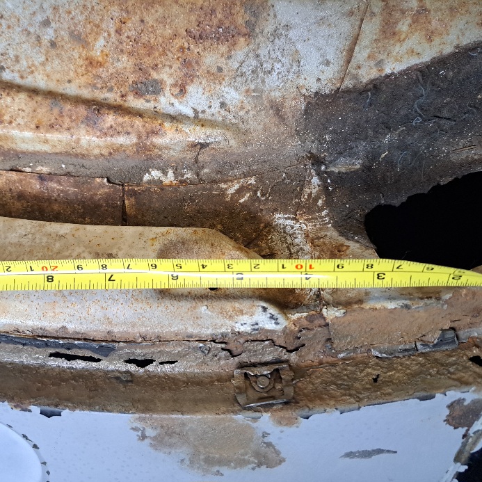 Rear windshield channel rust close up- passenger side lower corner